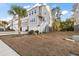 Townhouse exterior with a yard, driveway, and palm trees at 139 Winding River Dr, Johns Island, SC 29455