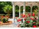 White gazebo surrounded by beautiful red roses at 6201 Portsman Ln, Summerville, SC 29485