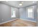 Bright bedroom with hardwood floors and two windows at 35 Cypress St, Charleston, SC 29403