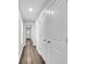 Light-filled hallway with wood-look flooring and access to multiple rooms at 2711 Henry St, North Charleston, SC 29405