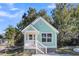 Charming light green house with white trim and a front porch at 2711 Henry St, North Charleston, SC 29405