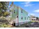 Charming light green house with white accents and a small deck at 2711 Henry St, North Charleston, SC 29405