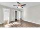 Spacious bedroom with hardwood floors, ceiling fan, and access to a full bathroom at 2711 Henry St, North Charleston, SC 29405
