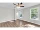 Bright bedroom with two windows, ceiling fan, and wood-look flooring at 2711 Henry St, North Charleston, SC 29405