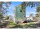 House exterior showcasing a light green color, white accents, and a backyard at 2711 Henry St, North Charleston, SC 29405