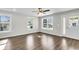 Living room with hardwood floors, large windows, and ceiling fan at 2711 Henry St, North Charleston, SC 29405
