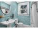 Updated bathroom features a pedestal sink, glass shelf, and a shower with a curtain at 112 Minus St, Saint George, SC 29477