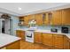 Kitchen boasts light wood cabinets, white countertop, stainless steel appliances, and hardwood floors at 112 Minus St, Saint George, SC 29477