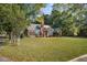 Brick house with lush green lawn and mature trees at 112 Minus St, Saint George, SC 29477