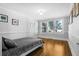 Bedroom with hardwood floors, a bed, and framed wall art with window view at 112 Minus St, Saint George, SC 29477
