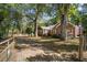 Brick house with long driveway, mature trees, and a gated entrance at 112 Minus St, Saint George, SC 29477
