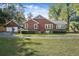 Brick home with attached garage and a large grassy yard at 112 Minus St, Saint George, SC 29477