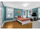 Cozy bedroom with hardwood floors, teal walls, and built-in workspace at 112 Minus St, Saint George, SC 29477