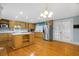 Kitchen boasts an island, stainless steel appliances, light wood cabinets, and hardwood floors at 112 Minus St, Saint George, SC 29477