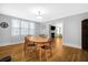 Bright dining room features hardwood floors, wood dining table with four chairs, and view into living room at 112 Minus St, Saint George, SC 29477