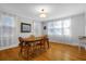 Bright dining room with hardwood floors, wood table and chairs, and large windows at 112 Minus St, Saint George, SC 29477