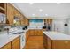 Kitchen has an island, white countertop, stainless steel appliances, and light wood cabinets at 112 Minus St, Saint George, SC 29477