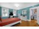 Bedroom with hardwood floors, teal walls, and access to laundry area at 112 Minus St, Saint George, SC 29477
