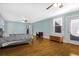 Spacious main bedroom with hardwood floors, ceiling fan, and access to private deck at 112 Minus St, Saint George, SC 29477