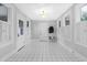 Bright entryway with white tile floor, white walls, and white shutters at 112 Minus St, Saint George, SC 29477