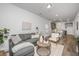 Open concept living room, dining, and kitchen area with hardwood floors at 104 Aplomb Aly # 16, Charleston, SC 29414