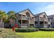 Two-story condo building with multiple balconies and lush landscaping at 1323 Pelican Watch Villas, Seabrook Island, SC 29455