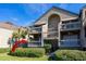 Two-story condo building with multiple balconies and lush landscaping at 1323 Pelican Watch Villas, Seabrook Island, SC 29455