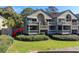 Two-story condo building with multiple balconies and lush landscaping at 1323 Pelican Watch Villas, Seabrook Island, SC 29455