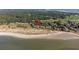 Aerial view of coastal community, showing beach, golf course, and multiple houses at 1323 Pelican Watch Villas, Seabrook Island, SC 29455