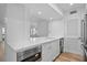 Kitchen with quartz countertops, white cabinets and built in microwave at 1323 Pelican Watch Villas, Seabrook Island, SC 29455