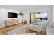 Living room features a large TV, sliding glass door to deck, water view at 1323 Pelican Watch Villas, Seabrook Island, SC 29455