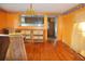 Orange dining room with hardwood floors and built-in cabinetry at 150 M L King Blvd, Saint Stephen, SC 29479