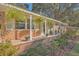 Covered porch with hanging plants and brick facade at 1839 Manigault Pl, Charleston, SC 29407
