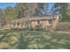 Brick ranch house with a covered porch and well-manicured lawn at 1839 Manigault Pl, Charleston, SC 29407