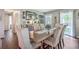 Bright dining area with hardwood floors, a rustic table, and access to backyard at 1839 Manigault Pl, Charleston, SC 29407