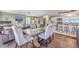 Open concept dining room with kitchen view, hardwood floors, and seating for six at 1839 Manigault Pl, Charleston, SC 29407