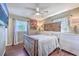 Relaxing bedroom with rustic wood bed frame and soft bedding at 1839 Manigault Pl, Charleston, SC 29407