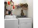 Functional laundry room with washer, dryer, and overhead storage at 476 Rockville Rd, Moncks Corner, SC 29461