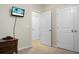 Simple bedroom with double doors and a mounted television at 476 Rockville Rd, Moncks Corner, SC 29461
