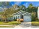Gray house with white garage door and landscaping at 476 Rockville Rd, Moncks Corner, SC 29461