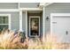 House exterior with gray siding, black front door and landscaping at 476 Rockville Rd, Moncks Corner, SC 29461
