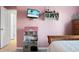 bedroom with pink walls, mounted TV, and toy kitchen at 476 Rockville Rd, Moncks Corner, SC 29461