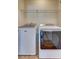 Bright laundry room with Maytag washer and dryer, and overhead shelving at 1751 Bee Balm Rd Rd, Johns Island, SC 29455
