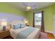 Charming bedroom with light green walls, a queen-size bed and hardwood floors at 1751 Bee Balm Rd Rd, Johns Island, SC 29455