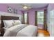 Bedroom with purple walls, hardwood floors, and patterned curtains at 1751 Bee Balm Rd Rd, Johns Island, SC 29455