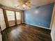 Bright bedroom with dark wood floors and blue accent wall at 221 Alston Cir, Goose Creek, SC 29445