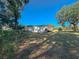 Spacious backyard with large trees and a partially visible deck at 6805 Sc-162, Hollywood, SC 29449