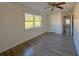 Well-lit bedroom with hardwood floors, a ceiling fan, and ample closet space at 6805 Sc-162, Hollywood, SC 29449