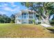 Two-story home with a wraparound porch and a hammock in the yard at 1109 Pinefield Dr, Wando, SC 29492