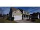 Two-story house with a white garage door and a landscaped yard at 1450 Coopers Hawk Dr, Hanahan, SC 29410